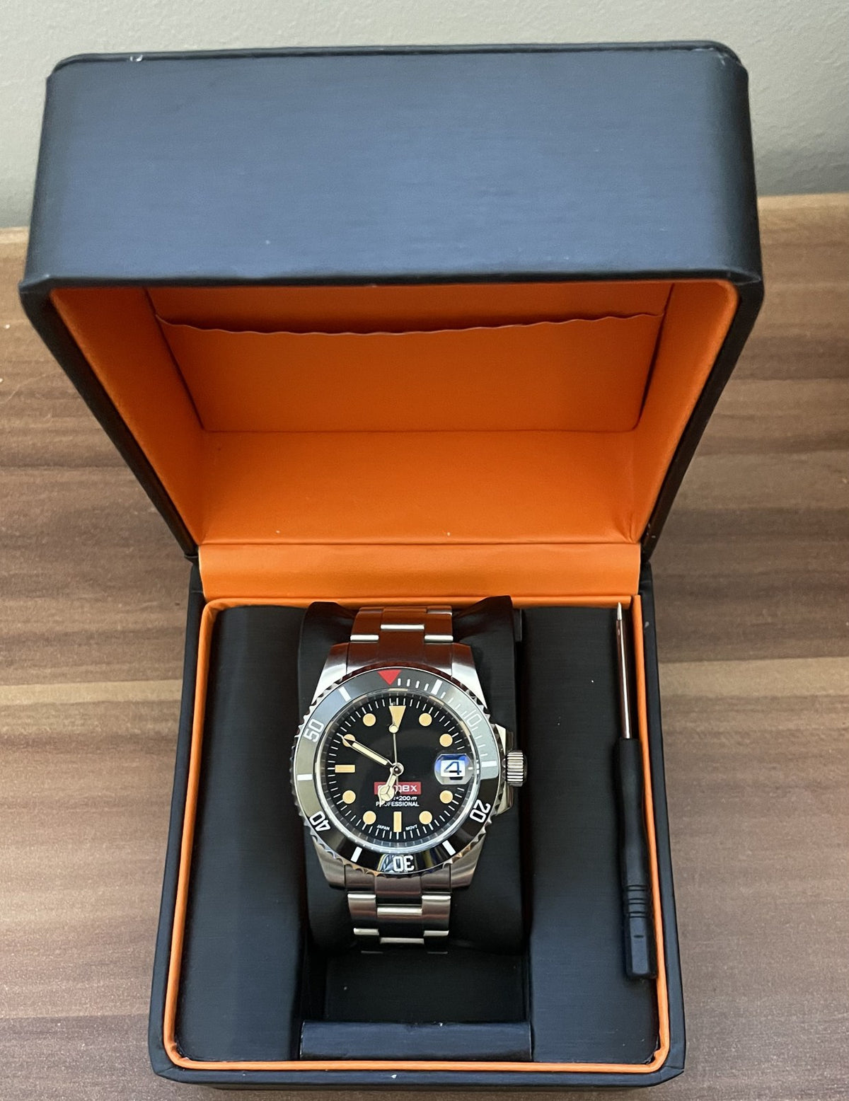 La montre Austral COMEX dans son écrin, avec l'outil de réglage du bracelet